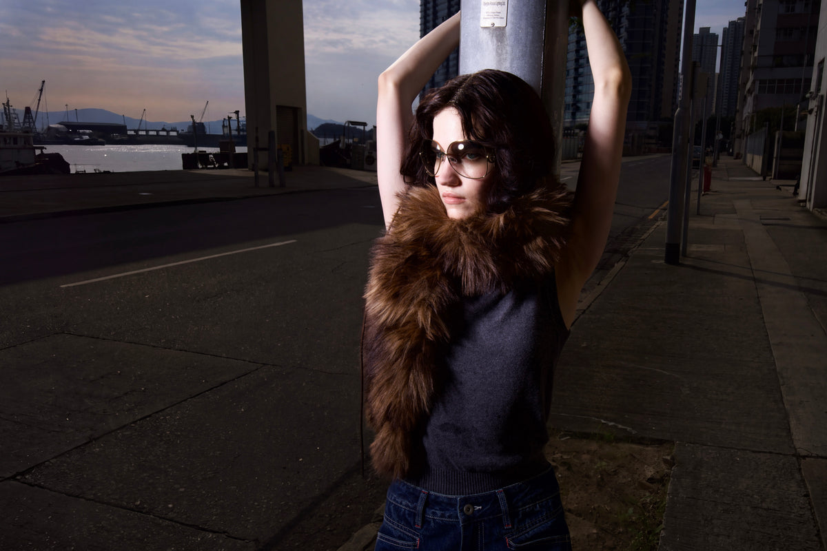 TAYACU campaign — model wearing sunglasses by the waterfront